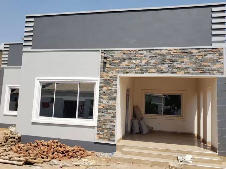 Stone-clad facade with grey rendered walls